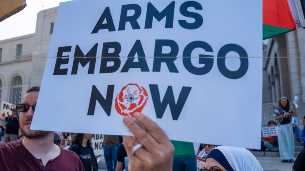 Sign at a protest supporting arms embargo against Israel